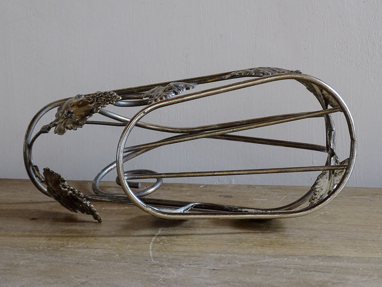 Mid-century metal wine bottle holder decorated with grapes and vine leaves