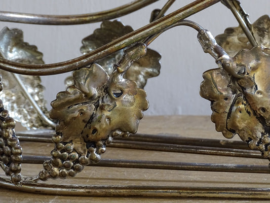 Decorative vineyard style wine bottle carrier with repoussé grape leaf details