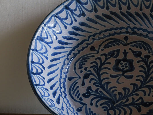 Rustic Spanish earthenware bowl with cobalt blue traditional painted pomegranate motifs