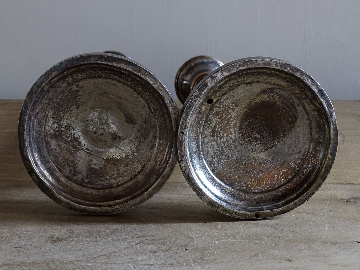 Antique silver-plated candlesticks from France with aged silver finish and decorative relief motifs
