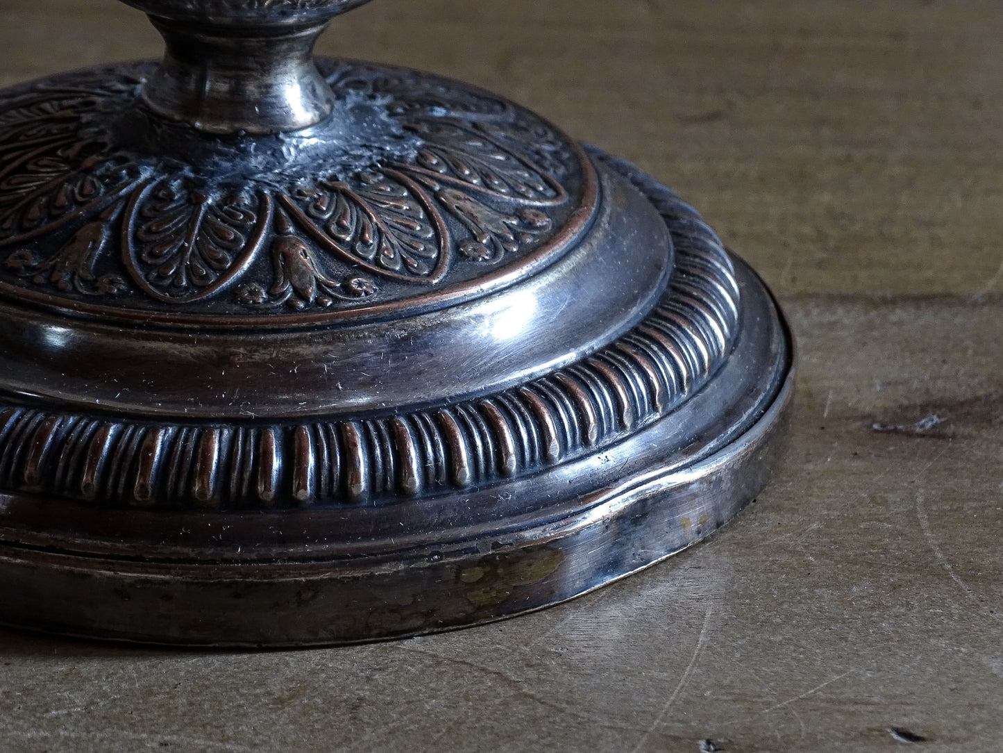 Pair of French antique silver plate over copper candlesticks with richly detailed ornamentation