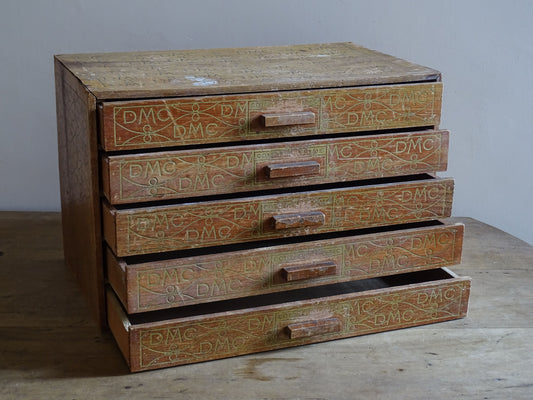 Early 20th century French haberdashery cabinet with printed DMC motif