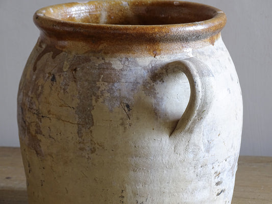 Rustic French pottery confit pot with twin handles and caramel glaze rim