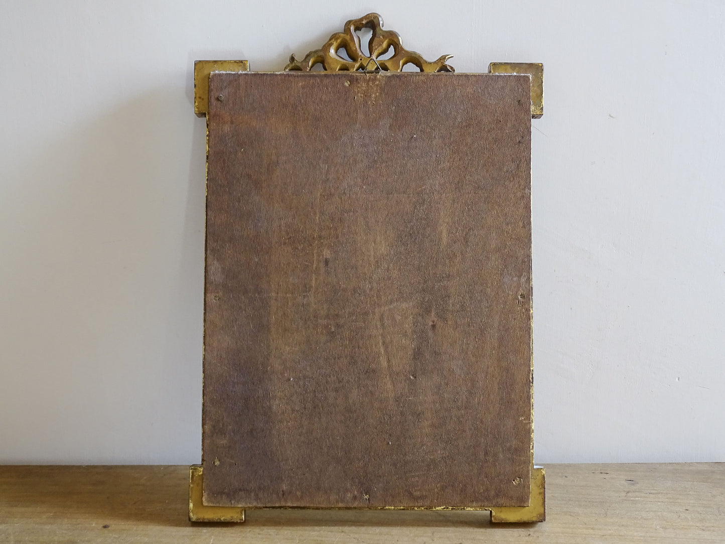 Rear view of French vintage gilt mirror showing original backboard and construction