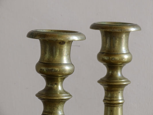 Early 20th century brass candlesticks with classic baluster stems.