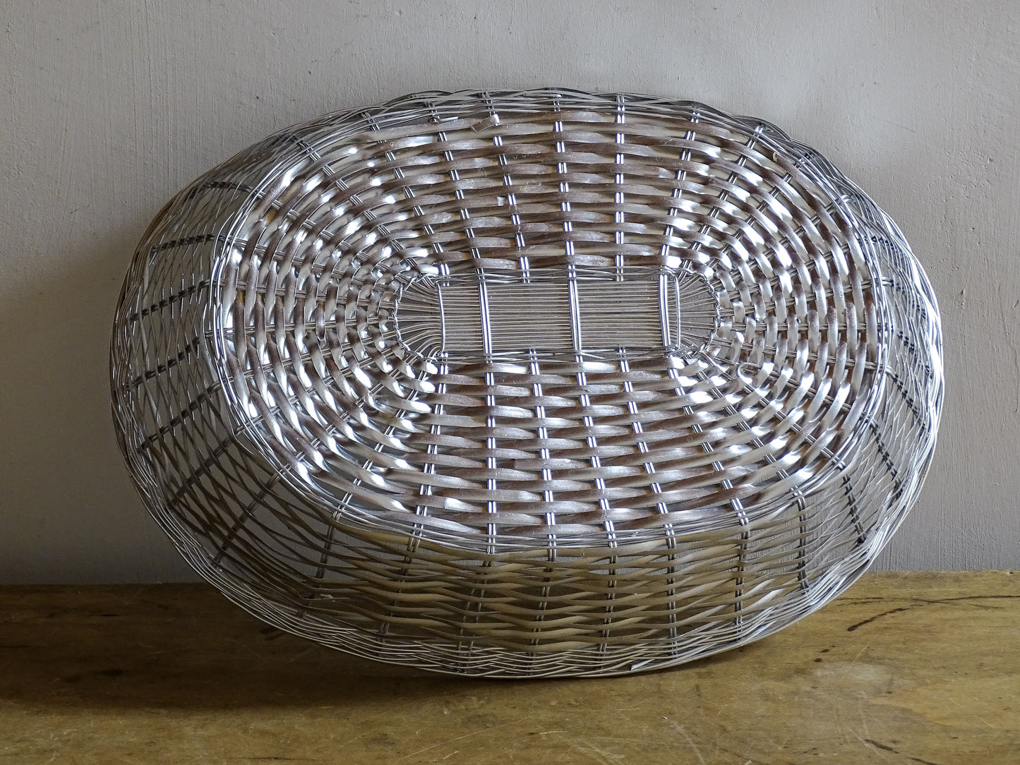 A French vintage silver coloured wire basket with an elegant elongated oval shape and finely woven construction.