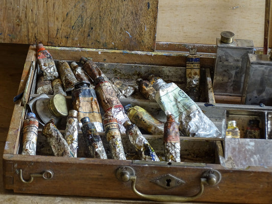 Antique wooden painter’s box containing old oil paints, brushes and studio materials