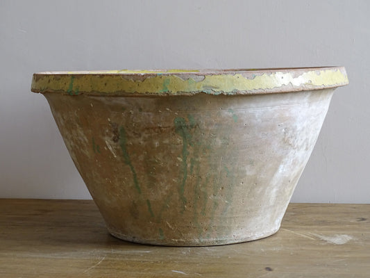 Large rustic French ceramic bowl with distressed yellow interior glaze