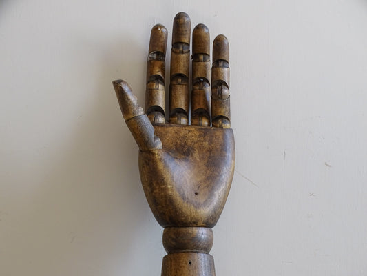 Mid-century articulated wooden mannequin hand with individually jointed fingers and aged brown finish