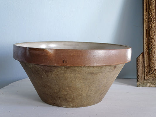 Large French antique pottery mixing bowl with earthy exterior, wide brown glazed rim and impressed number 15.
