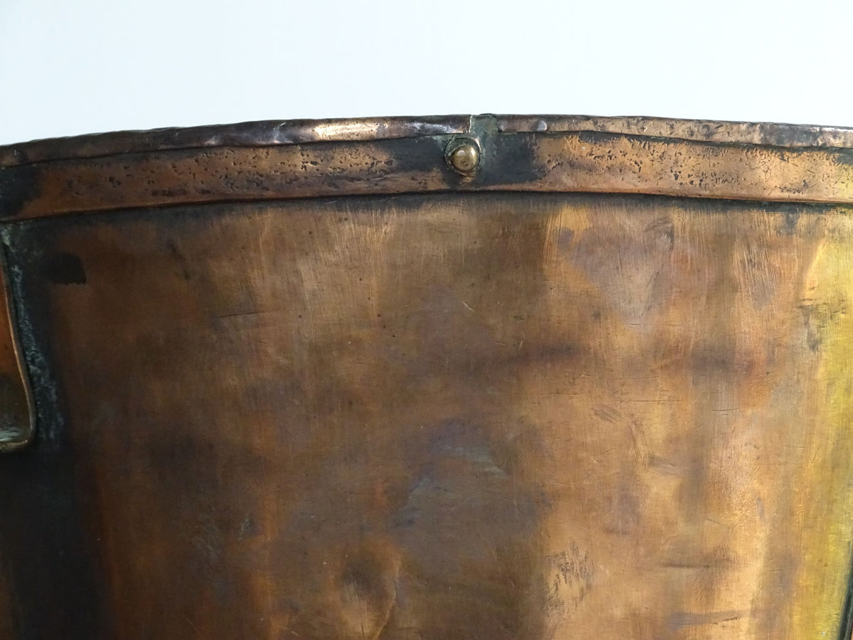 Large antique French copper pail with aged finish, originally used as a water vessel, shown on a plain white background.