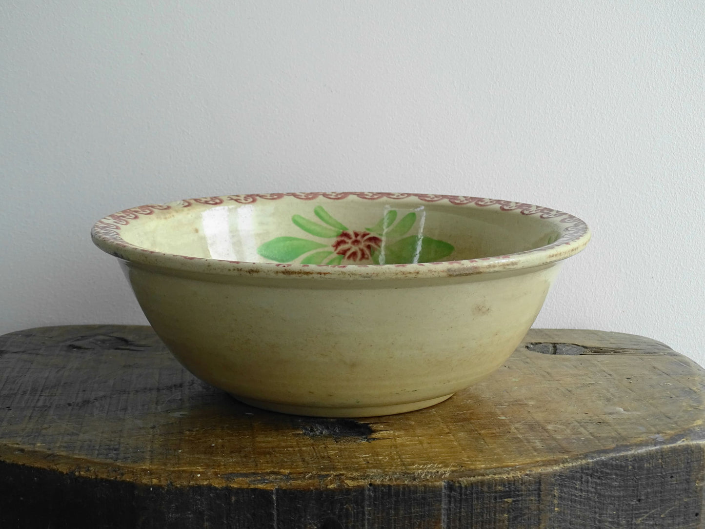 Antique Saint Amand Salad Bowl with Figure of a man and foliage and flower decoration