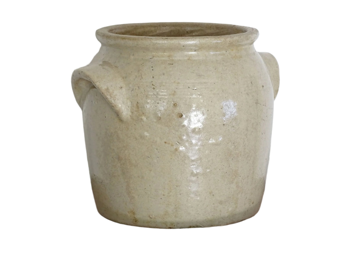 Antique French stoneware confit pot or preserving pot glazed in a pale oatmeal or sand colour. This crock pot or cache pot has two curved handles to each side.