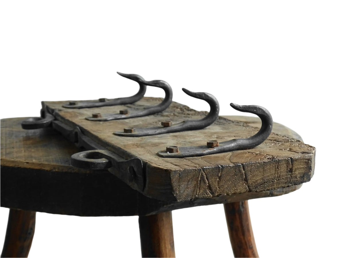 Antique Wrought Iron Hooks on Aged Wood for a French country farmhouse kitchen decor.