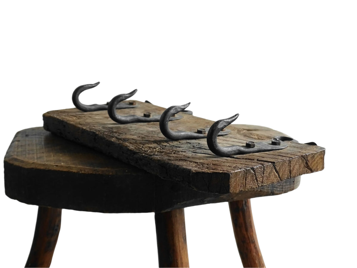 Antique Wrought Iron Hooks on Aged Wood for a French country farmhouse kitchen decor.