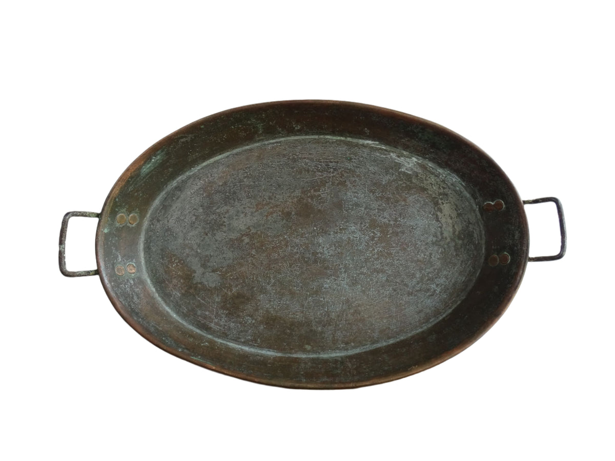 French antique copper gratin pan with two handles and tinned interior. Oval copper pan with patina.