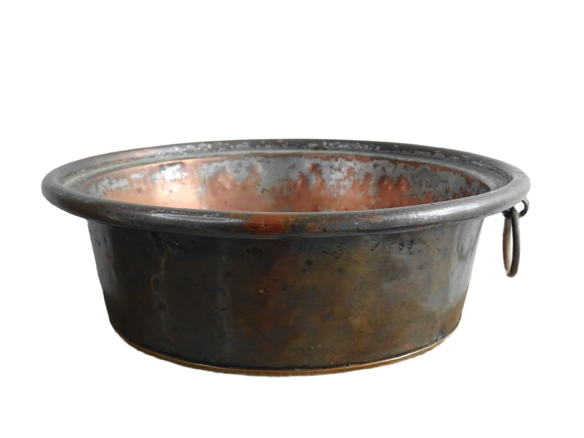 French antique copper mixing bowl with rolled top and handle. Copper bowl with timeworn appearance for a French country farmhouse kitchen.