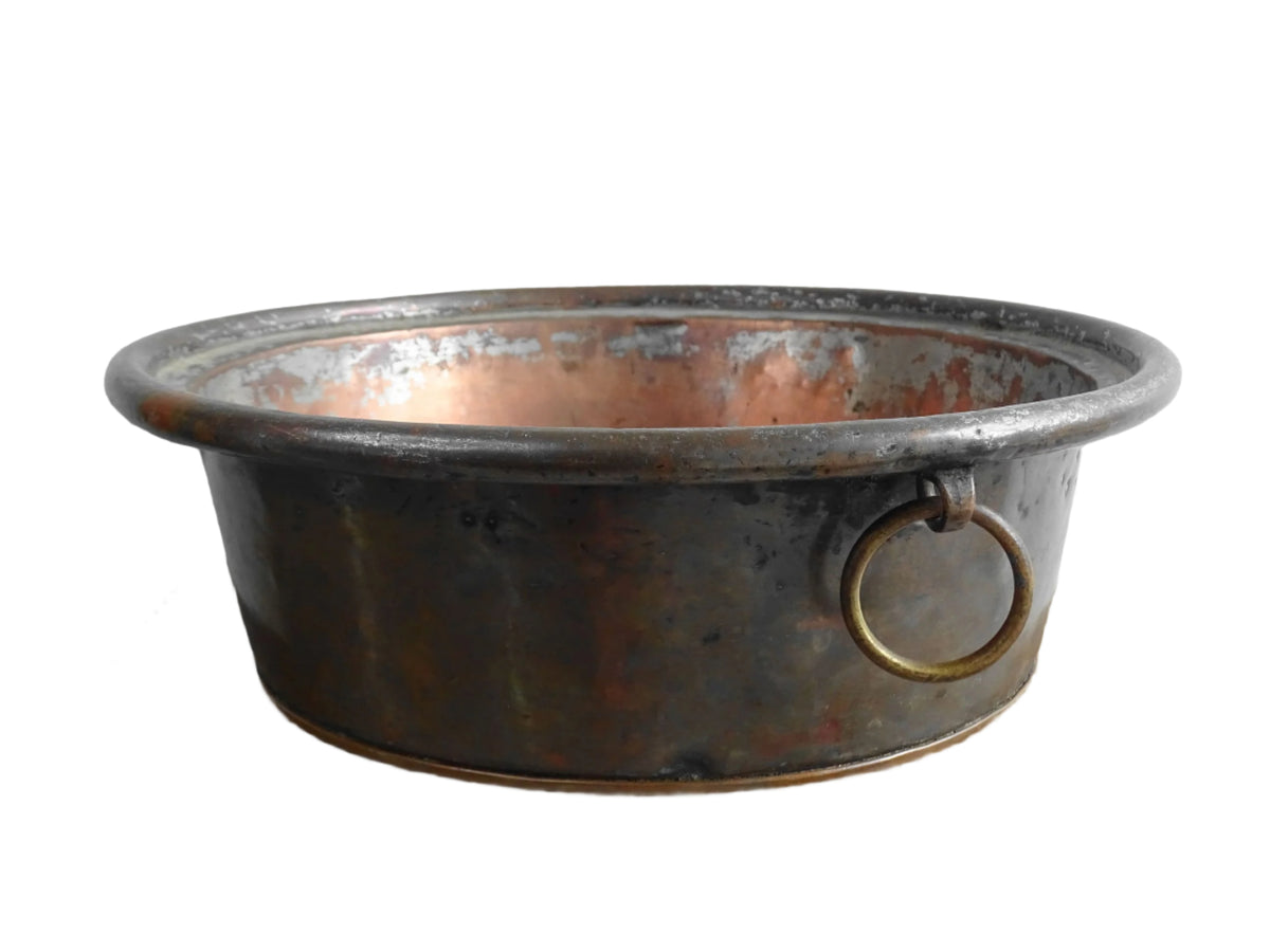 French antique copper mixing bowl with rolled top and handle. Copper bowl with timeworn appearance for a French country farmhouse kitchen.