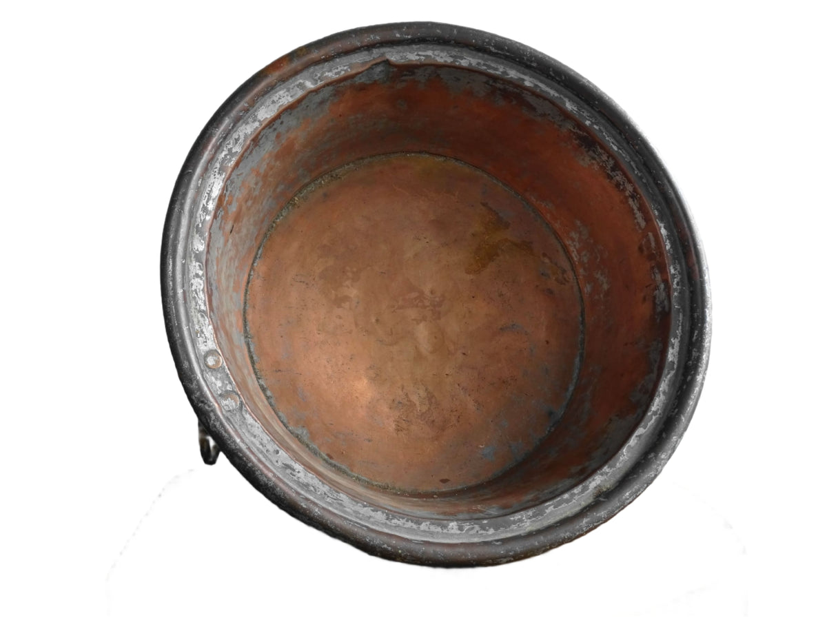 French antique copper mixing bowl with rolled top and handle. Copper bowl with timeworn appearance for a French country farmhouse kitchen.