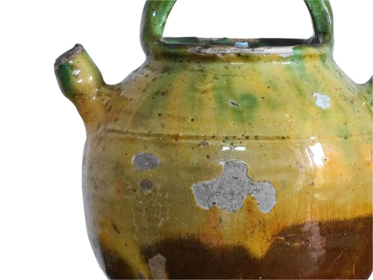 French antique gargoulette with green and yellow glaze from Provence. Antique water jug with a handle to the top and side, plus a small spout. Pottery pitcher for Provençal kitchen decor.