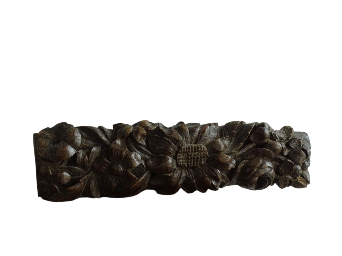 French antique wooden carving with sunflowers and roses. Old wood carving for display.