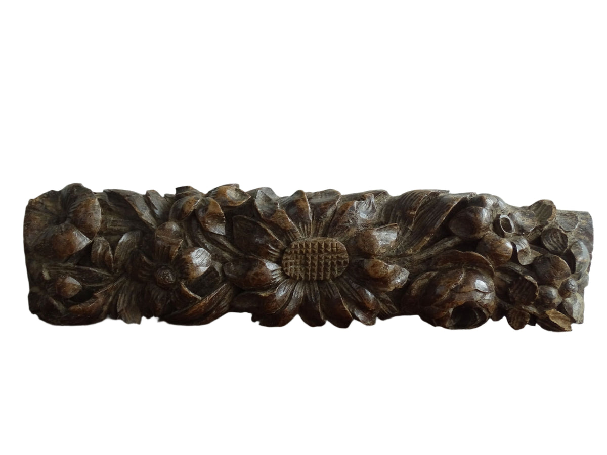 French antique wooden carving with sunflowers and roses. Old wood carving for display.