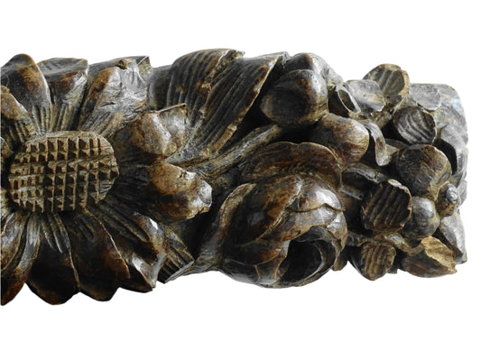 French antique wooden carving with sunflowers and roses. Old wood carving for display.