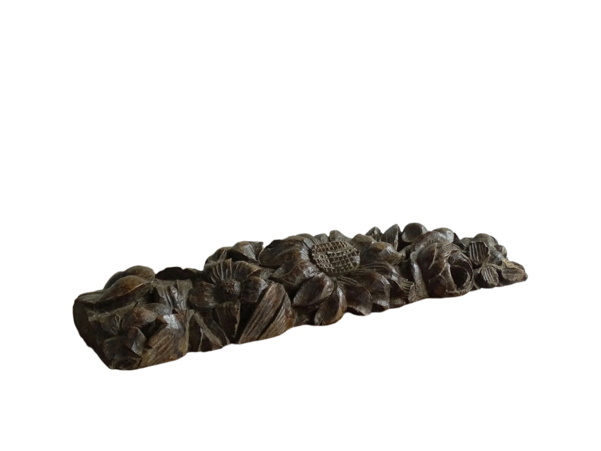 French antique wooden carving with sunflowers and roses. Old wood carving for display.