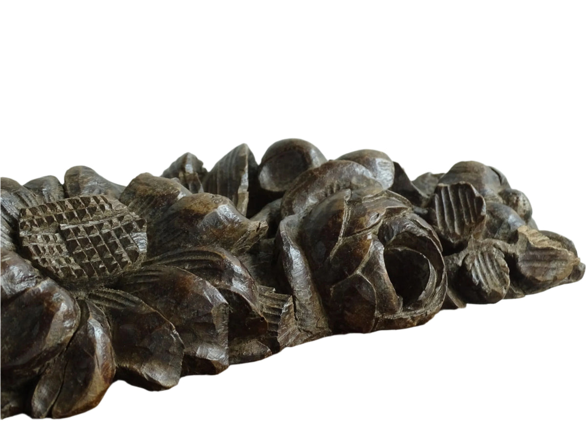 French antique wooden carving with sunflowers and roses. Old wood carving for display.