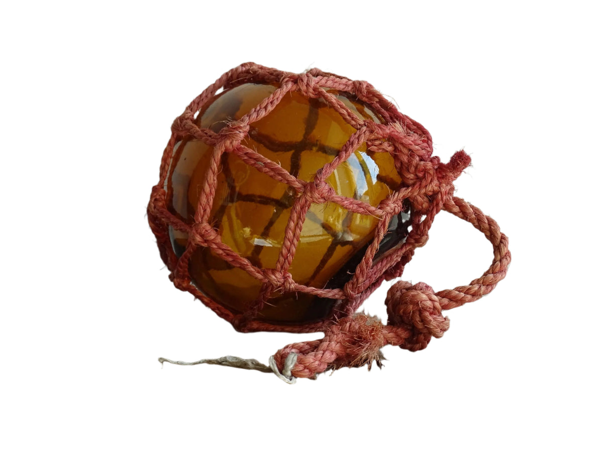 French vintage glass fishing float in amber glass with red rope