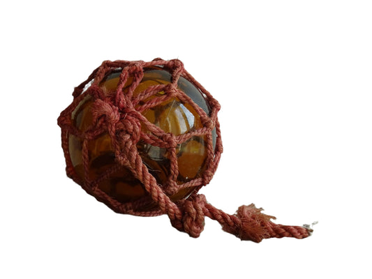 French vintage glass fishing float in amber glass with red rope