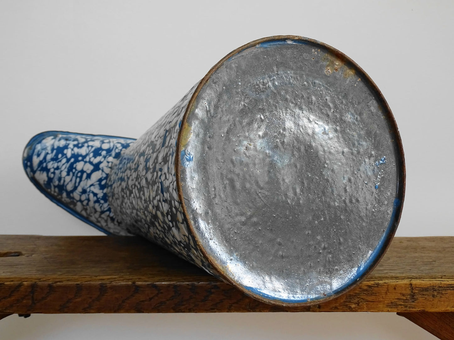 Large French vintage enamel pitcher in blue and white with a decorative swirl effect. Enamelware pitcher with large handle and spout. Vintage enamel jug for kitchen decor.