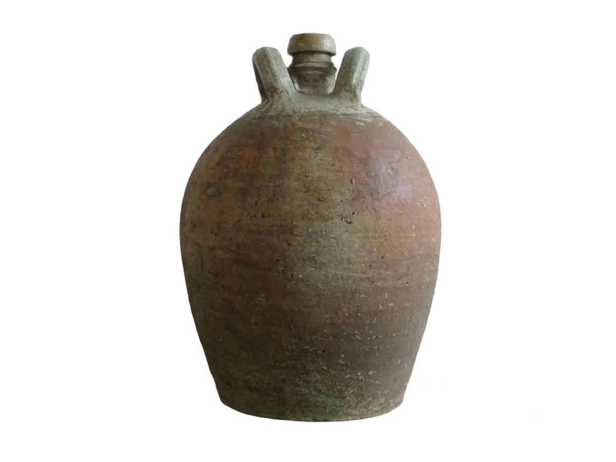 Large French antique terracotta pitcher. Rustic jug with a red brown tone to the body and a lighter tone to the two loop handles and spout. It has a rounded body and neutral tones. Antique earthenware pottery for rustic farmhouse decor.