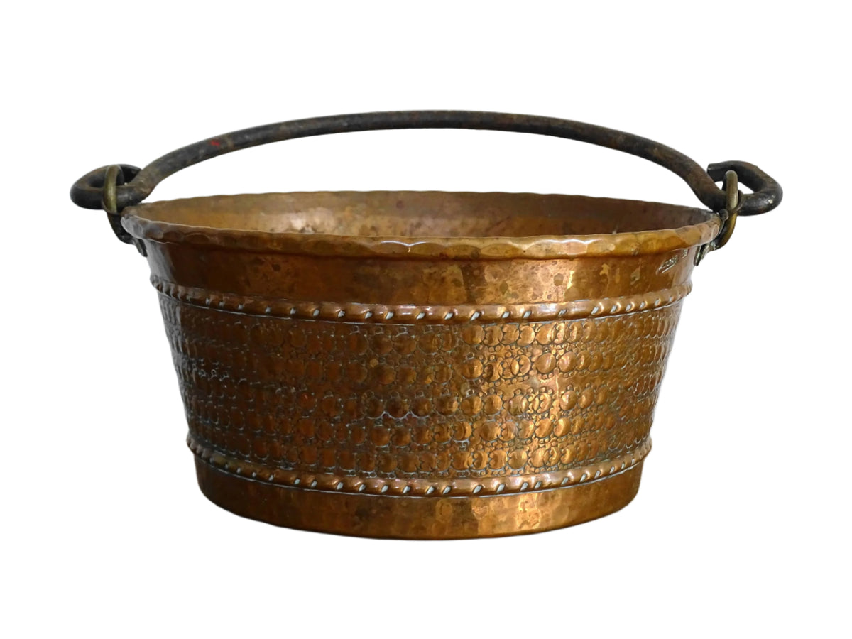 Small vintage copper cauldron with a hammered effect. It has a wrought iron handle and delicate brass detailing. Small copper cauldron or planter.