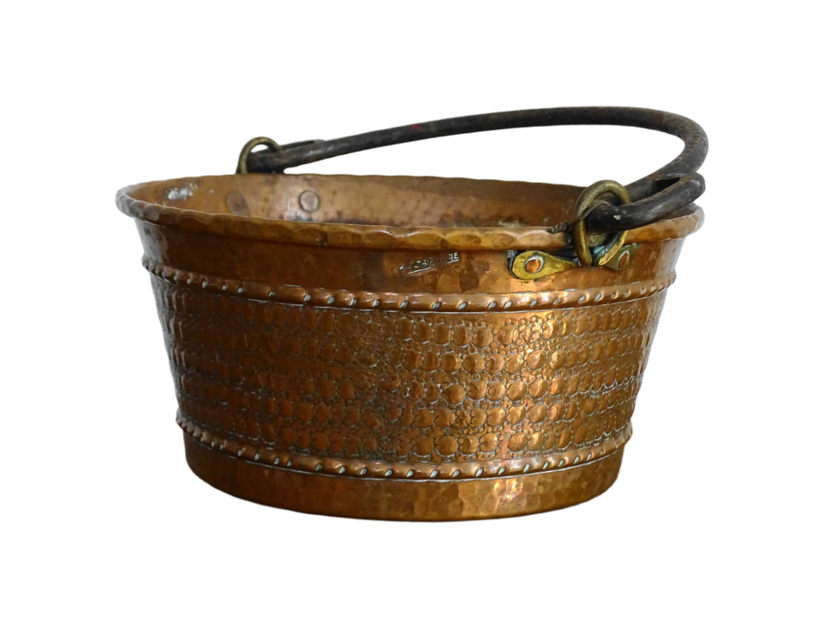 Small vintage copper cauldron with a hammered effect. It has a wrought iron handle and delicate brass detailing. Small copper cauldron or planter.