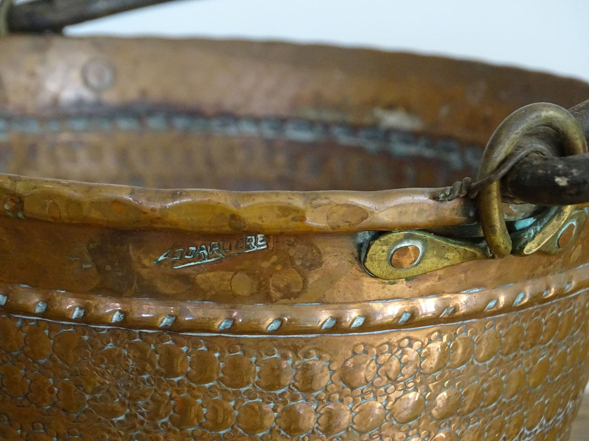 Small vintage copper cauldron with a hammered effect. It has a wrought iron handle and delicate brass detailing. Small copper cauldron or planter.
