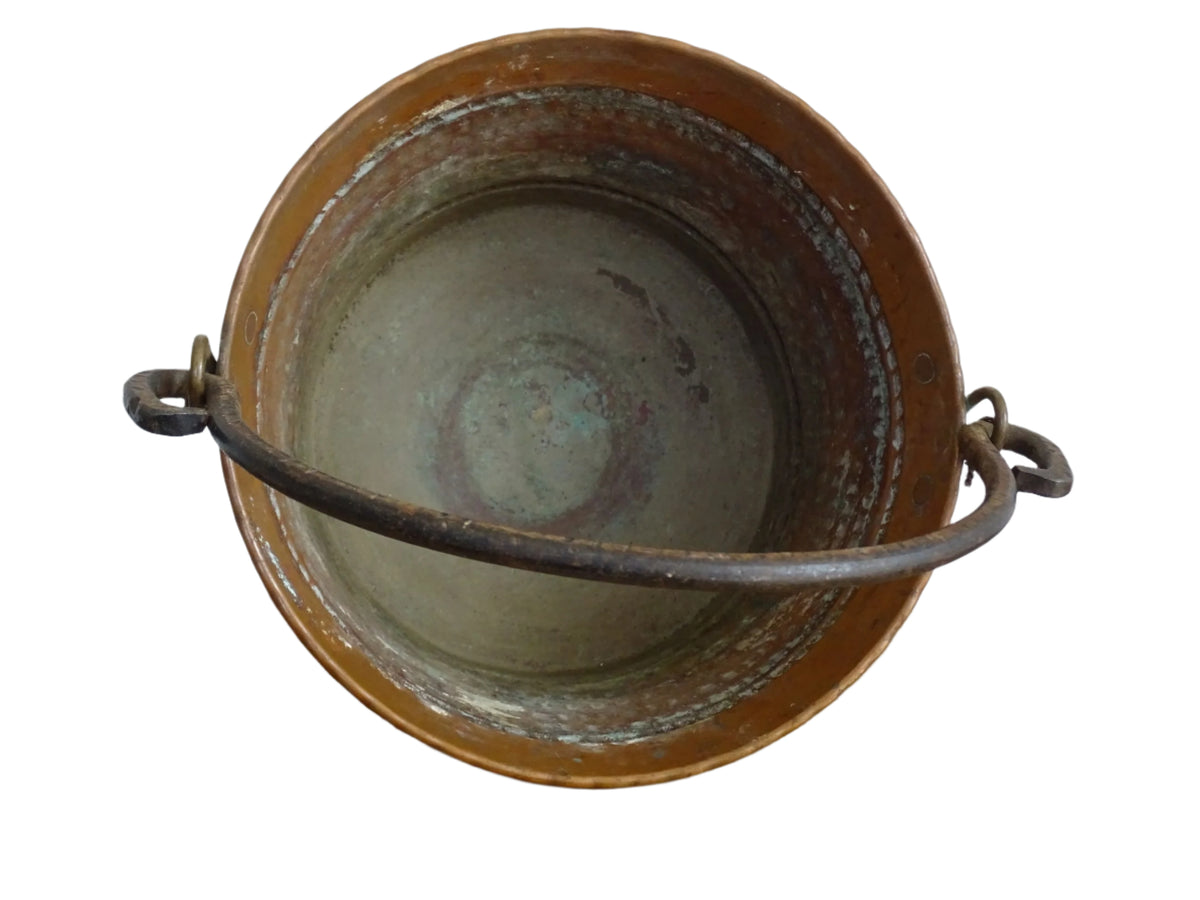 Small vintage copper cauldron with a hammered effect. It has a wrought iron handle and delicate brass detailing. Small copper cauldron or planter.