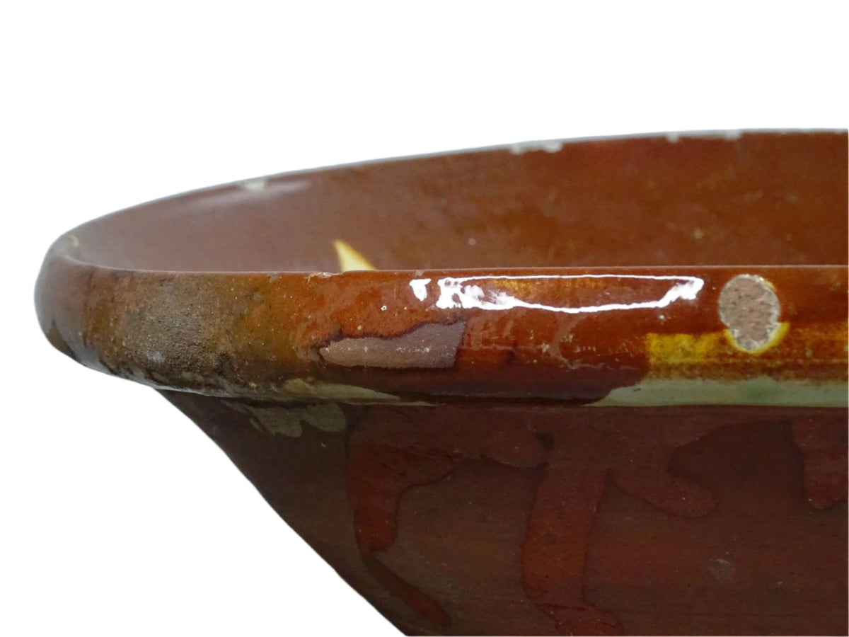 Spanish antique terracotta bowl or basin with a brown and yellow glaze to the interior. This pottery bowl has a timeworn patina.