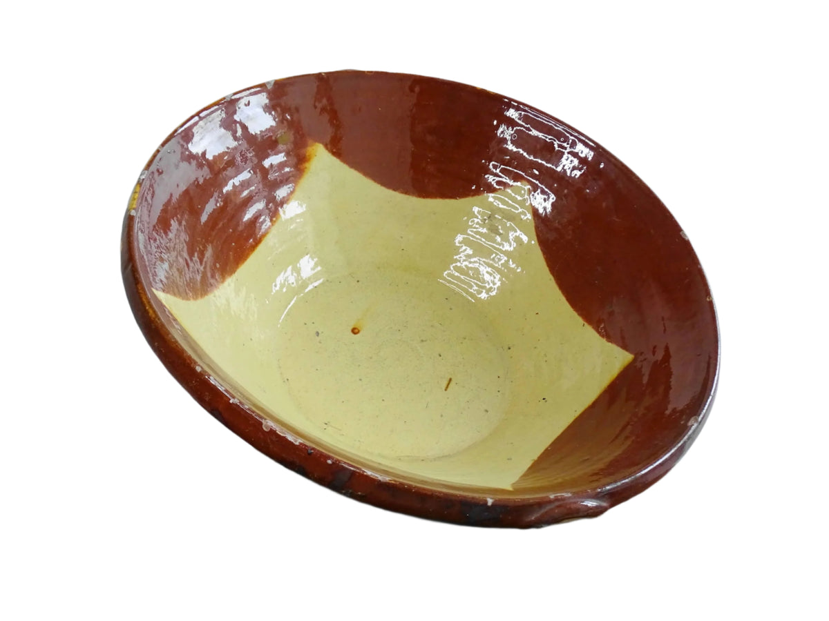 Spanish antique terracotta bowl or basin with a brown and yellow glaze to the interior. This pottery bowl has a timeworn patina.