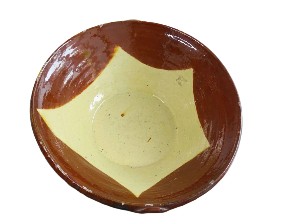 Spanish antique terracotta bowl or basin with a brown and yellow glaze to the interior. This pottery bowl has a timeworn patina.