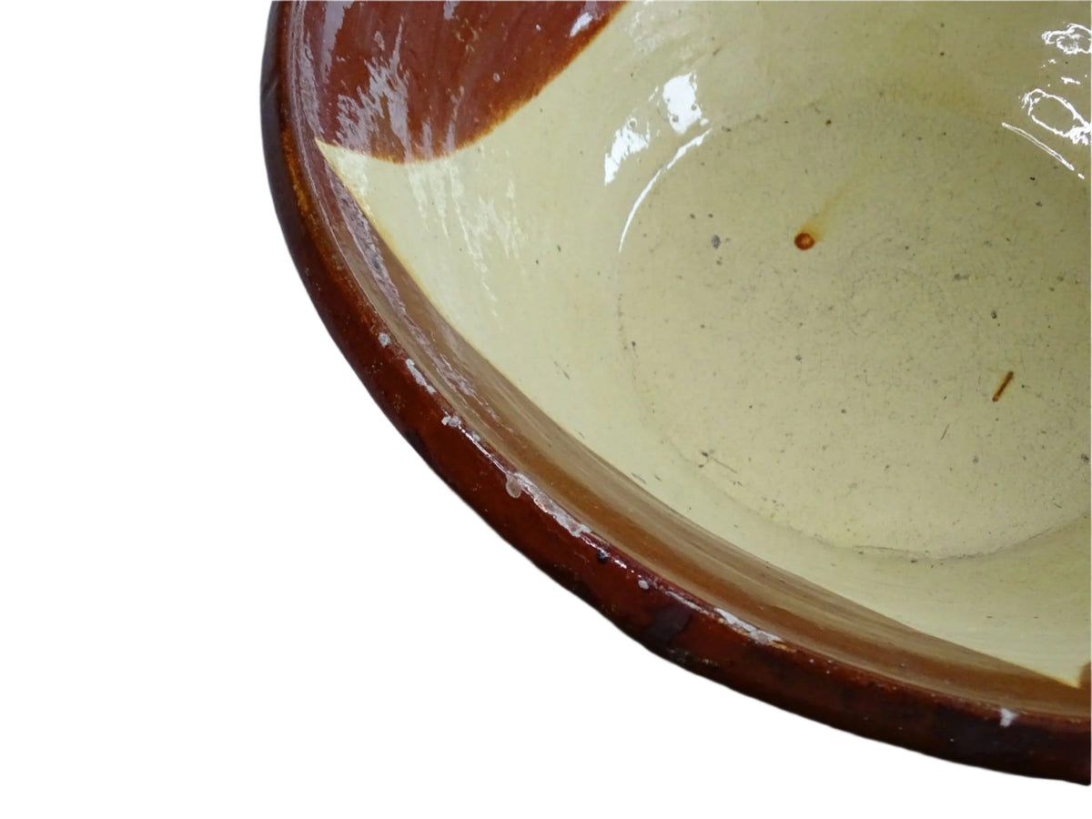 Spanish antique terracotta bowl or basin with a brown and yellow glaze to the interior. This pottery bowl has a timeworn patina.