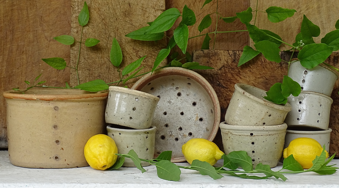 A collection of French antique earthenware pottery faisselles or cheese strainers. 