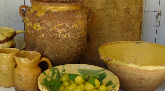 French antique pottery with a yellow glaze: confit pots, glazed pottery pitchers, earthenware tian bowls. 