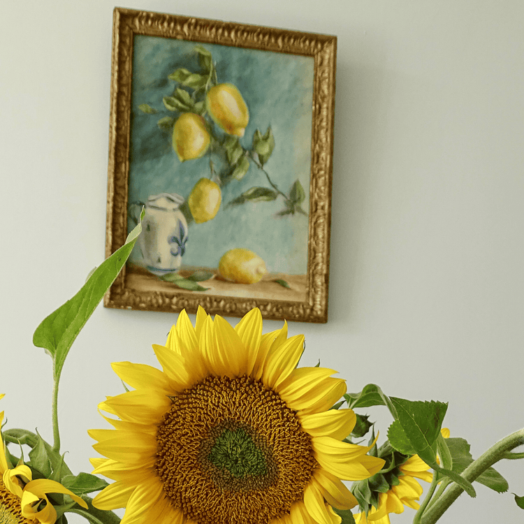Framed watercolour still life on the wall with a vase of sunflowers