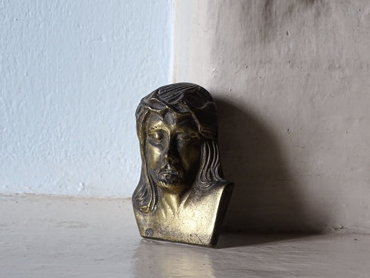 French vintage plaque of jesus displayed on a country house fireplace