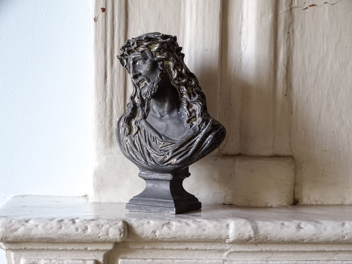 French antique bust of Christ in spelter, pictured on a country house fireplace