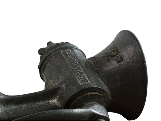 French vintage meat grinder marked 'Le Practique' with wooden handle
