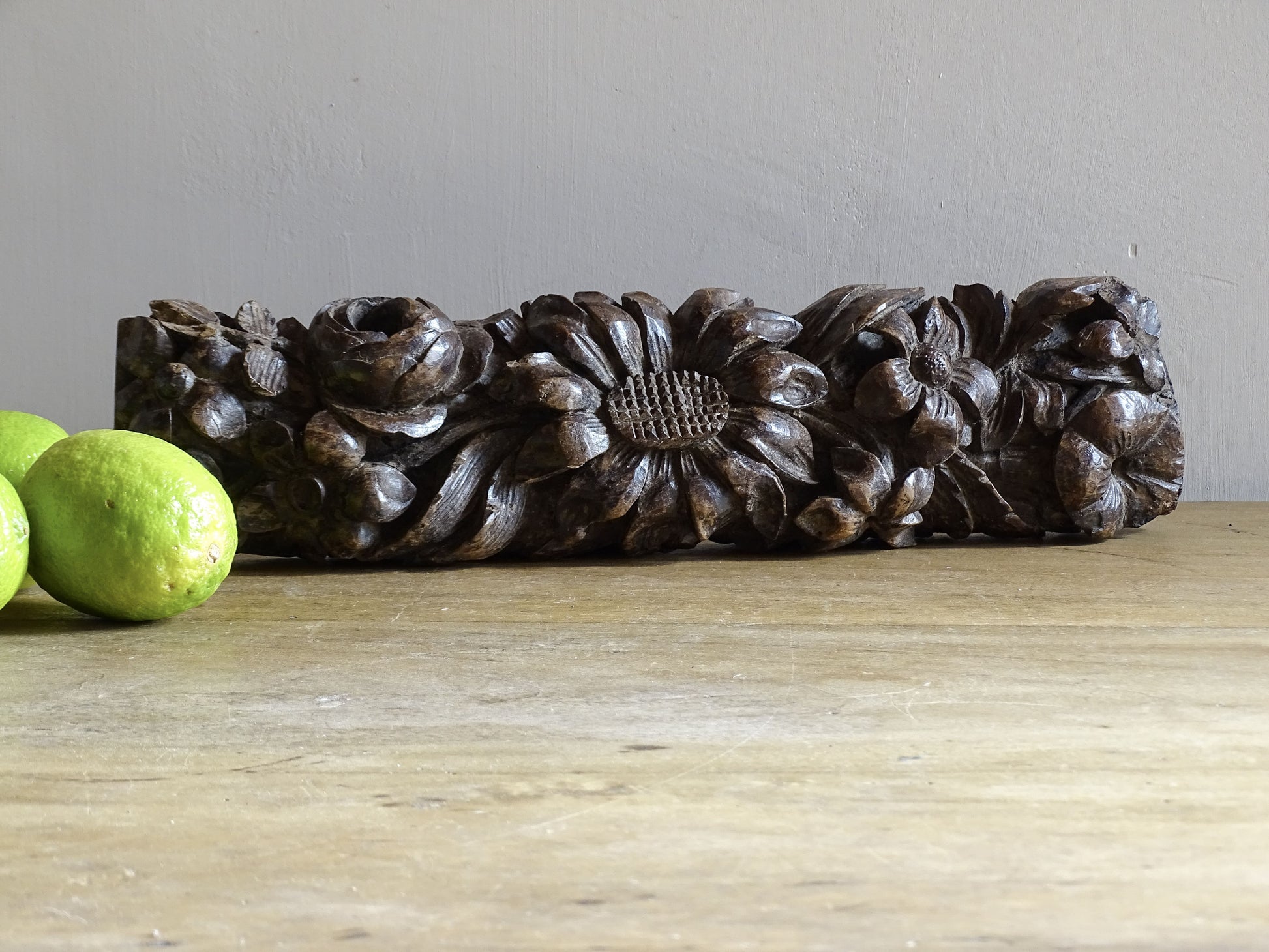 French antique wooden carving with sunflowers and roses. Old wood carving for display.
