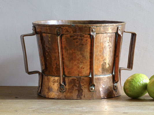 Small antique hammered copper vessel or ferrat with fine detailing and bright patina. Two handled copper pot.
