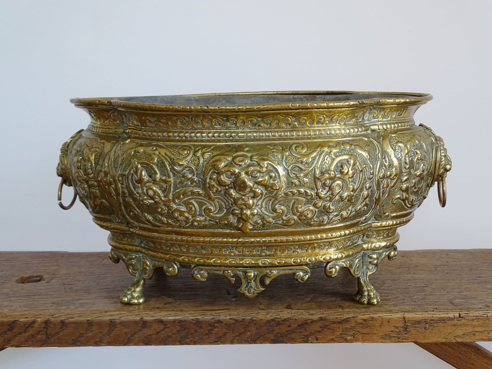 French antique brass jardinière with lion head handles and claw feet